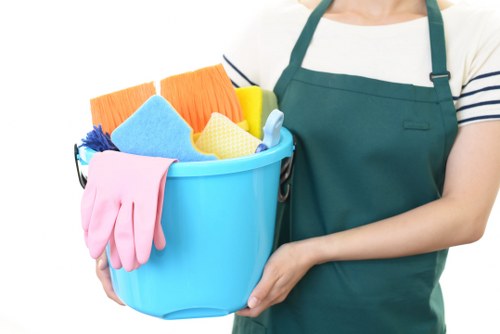 Professional cleaner organizing a living room