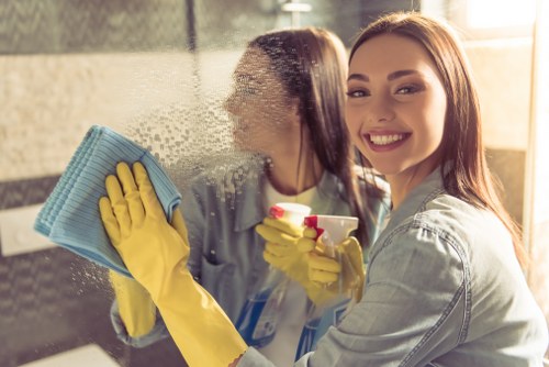 Staff wearing personal protective equipment during a cleaning task